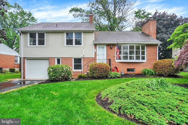 255 Folkstone Way, York, PA 17402 - split level home with a chimney, a garage, asphalt driveway, and brick siding