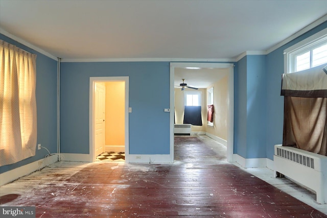 154 S Baltimore St, Dillsburg, PA 17019 - unfurnished living room with radiator, hardwood / wood-style floors, ceiling fan, baseboards, and crown molding