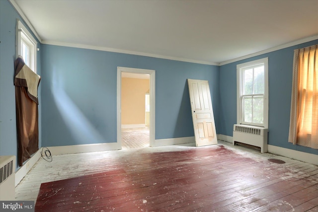 154 S Baltimore St, Dillsburg, PA 17019 - unfurnished room featuring radiator heating unit, wood-type flooring, healthy amount of natural light, ornamental molding, and baseboards