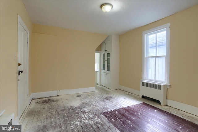 154 S Baltimore St, Dillsburg, PA 17019 - unfurnished room featuring radiator heating unit, hardwood / wood-style flooring, and baseboards