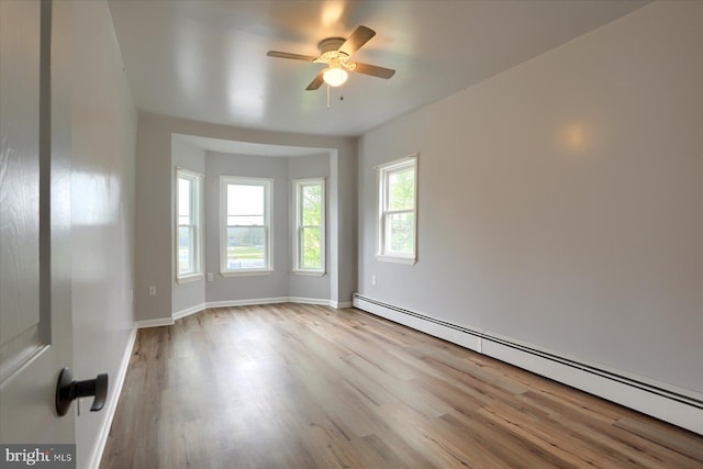 154 S Baltimore St, Dillsburg, PA 17019 - empty room featuring baseboard heating, ceiling fan, wood finished floors, and baseboards