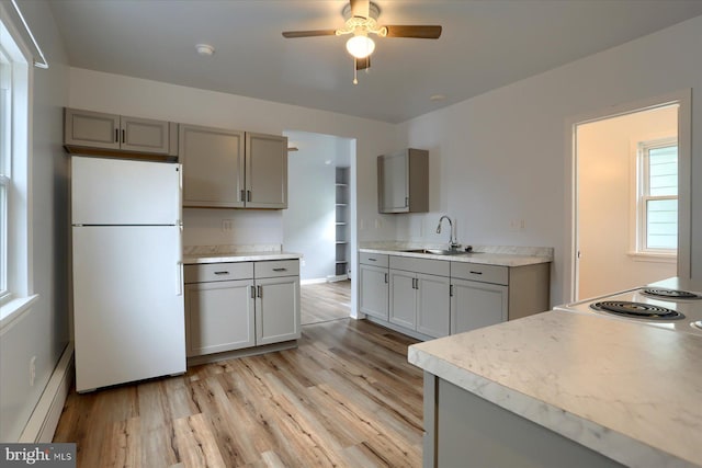 154 S Baltimore St, Dillsburg, PA 17019 - kitchen with freestanding refrigerator, gray cabinetry, a sink, light wood finished floors, and ceiling fan