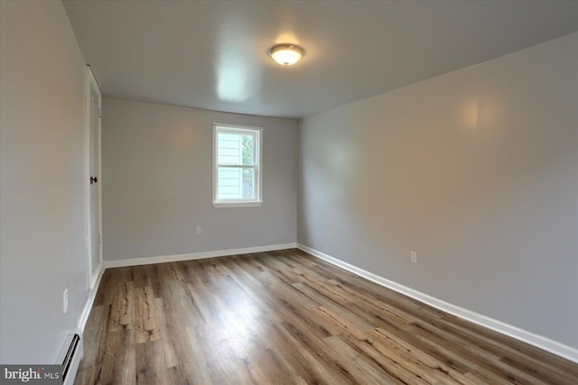 154 S Baltimore St, Dillsburg, PA 17019 - empty room with wood finished floors, baseboards, and a baseboard radiator