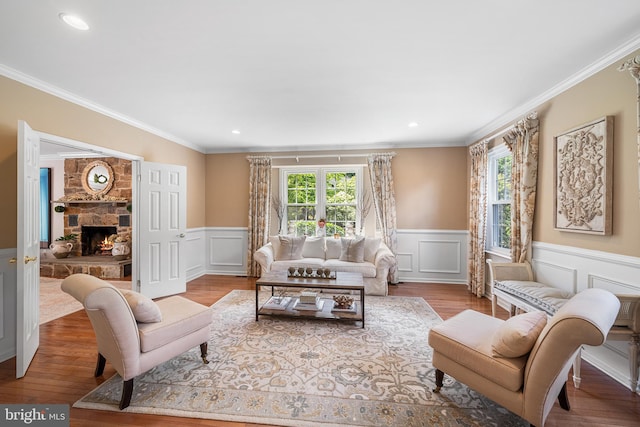 253 Lantern Ln, Gulph Mills, PA 19428 - living room featuring a decorative wall, ornamental molding, a wainscoted wall, wood finished floors, and a fireplace