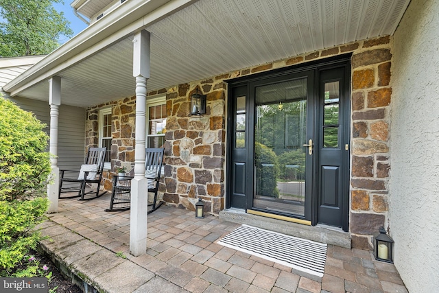 253 Lantern Ln, Gulph Mills, PA 19428 - view of exterior entry featuring a porch and stone siding