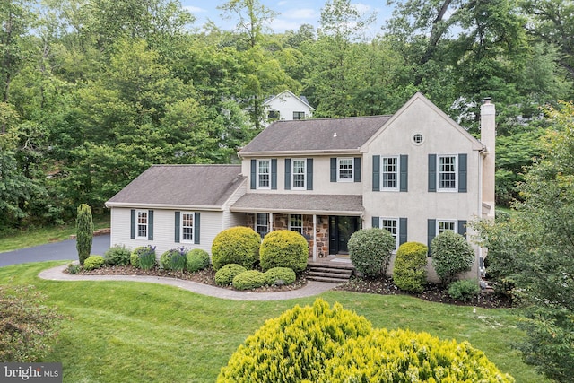 253 Lantern Ln, Gulph Mills, PA 19428 - colonial-style house with a porch, a chimney, a front lawn, and a shingled roof