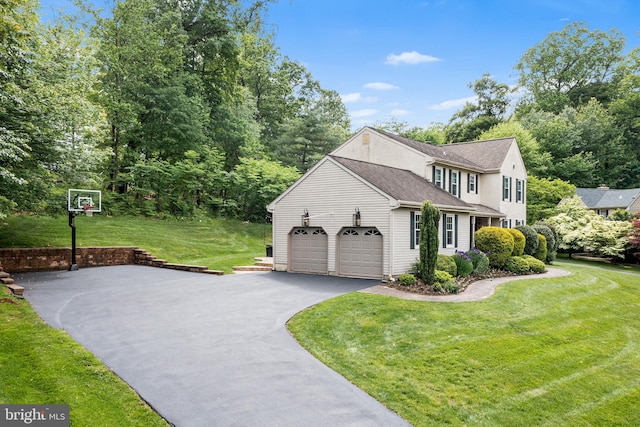 253 Lantern Ln, Gulph Mills, PA 19428 - view of property exterior featuring asphalt driveway, a yard, a garage, and roof with shingles