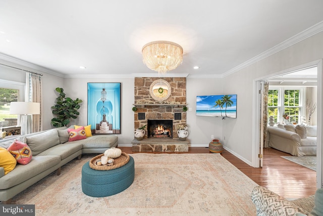 253 Lantern Ln, Gulph Mills, PA 19428 - living room with wood finished floors, ornamental molding, baseboards, a chandelier, and a stone fireplace
