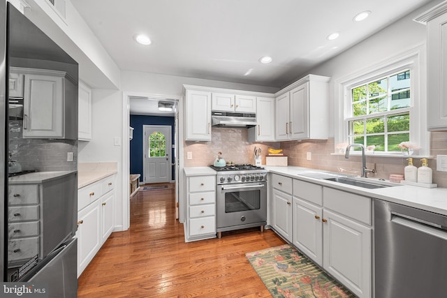 253 Lantern Ln, Gulph Mills, PA 19428 - kitchen with stainless steel appliances, a sink, under cabinet range hood, light countertops, and recessed lighting