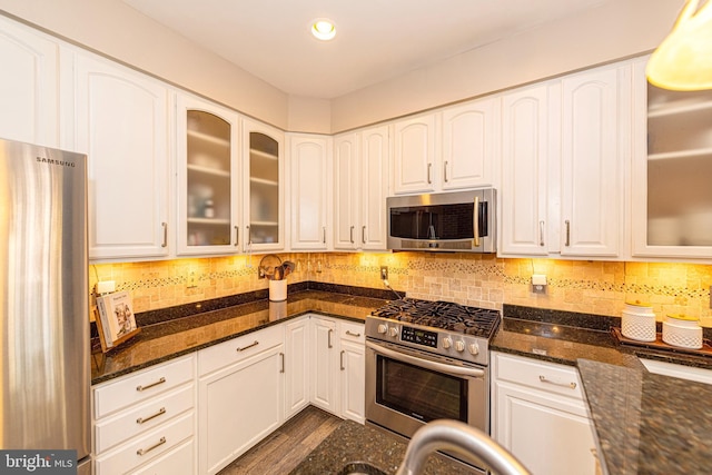 15381 Bronco Way, Woodbridge, VA 22193 - kitchen featuring stainless steel appliances, white cabinets, dark stone countertops, backsplash, and recessed lighting