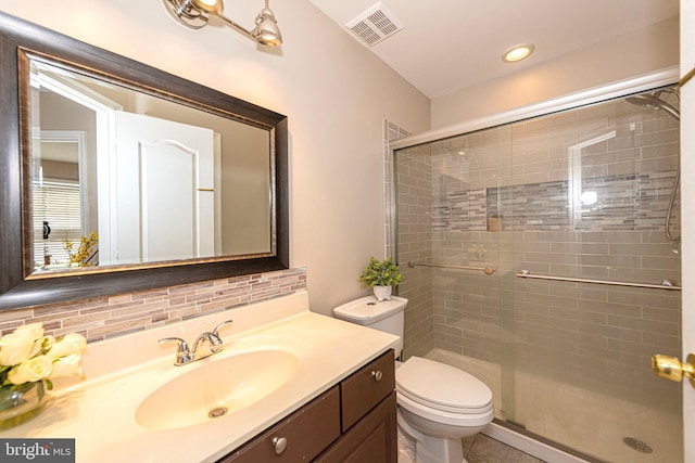 15381 Bronco Way, Woodbridge, VA 22193 - bathroom with vanity, a stall shower, decorative backsplash, and toilet
