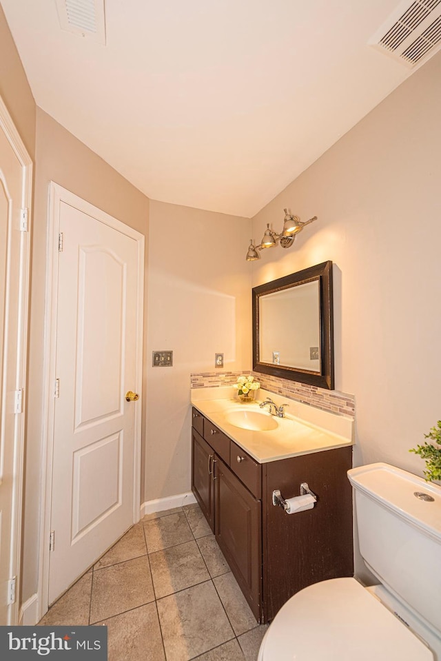 15381 Bronco Way, Woodbridge, VA 22193 - bathroom with vanity, toilet, tile patterned flooring, decorative backsplash, and baseboards