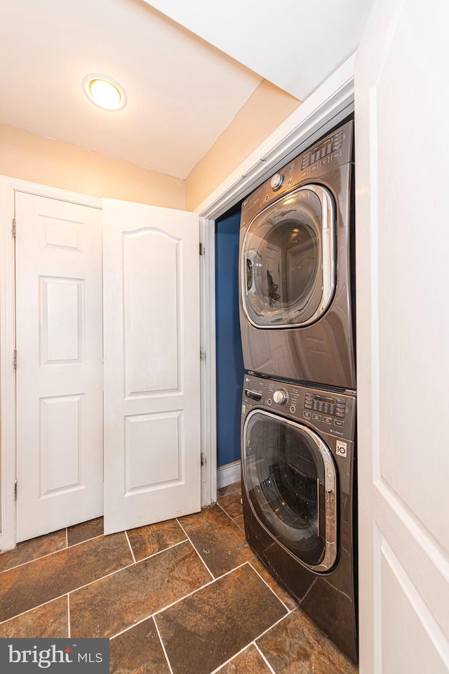 15381 Bronco Way, Woodbridge, VA 22193 - laundry area featuring stacked washer / drying machine and stone tile flooring