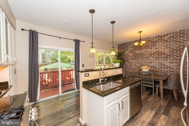 15381 Bronco Way, Woodbridge, VA 22193 - kitchen with a sink, appliances with stainless steel finishes, dark wood finished floors, dark stone counters, and white cabinets