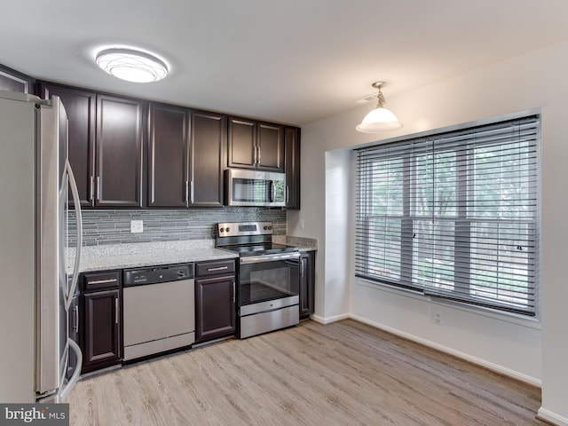 1447 Chatham Ct, Crofton, MD 21114 - kitchen featuring appliances with stainless steel finishes, light wood finished floors, tasteful backsplash, and dark brown cabinetry