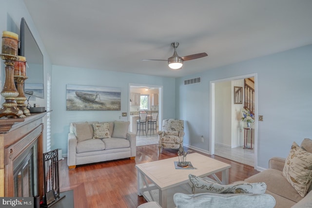 45 S Shore Dr, Dover, DE 19901 - living area featuring ceiling fan, wood finished floors, a fireplace, and baseboards