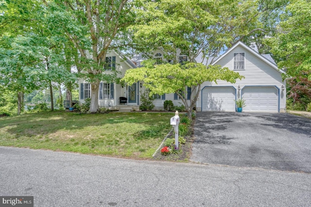 45 S Shore Dr, Dover, DE 19901 - view of front of house featuring asphalt driveway, a front lawn, and a garage