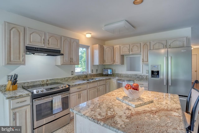 45 S Shore Dr, Dover, DE 19901 - kitchen featuring stainless steel appliances, under cabinet range hood, a sink, light stone counters, and a kitchen island