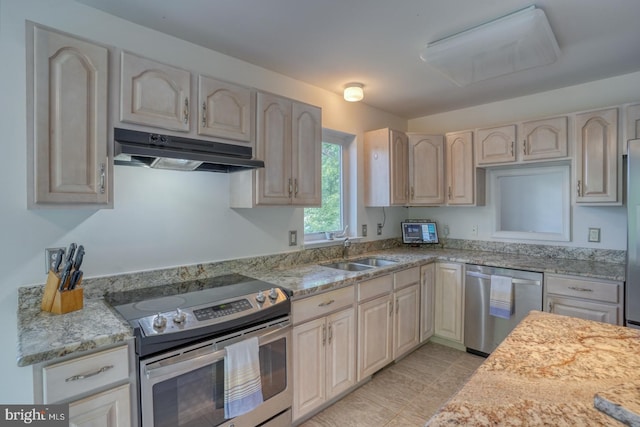 45 S Shore Dr, Dover, DE 19901 - kitchen featuring stainless steel appliances, under cabinet range hood, a sink, and light stone counters