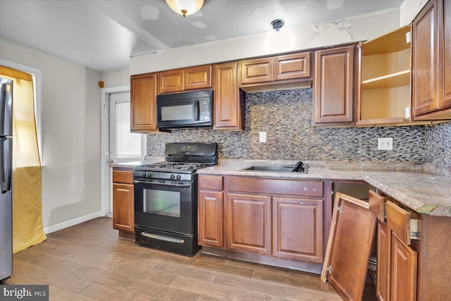 7175 Lee Ave, Pennsauken, NJ 08110 - kitchen with black appliances, open shelves, decorative backsplash, and light wood-type flooring