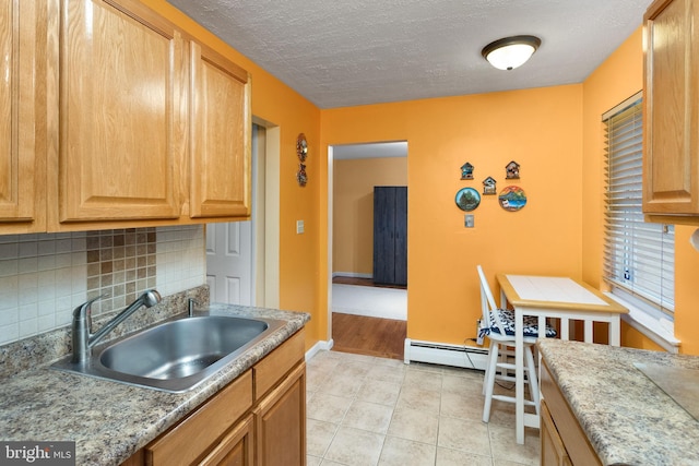 132 The Orchards Unit I, East Windsor, NJ 08520 - kitchen with a sink, backsplash, light tile patterned flooring, baseboards, and a textured ceiling