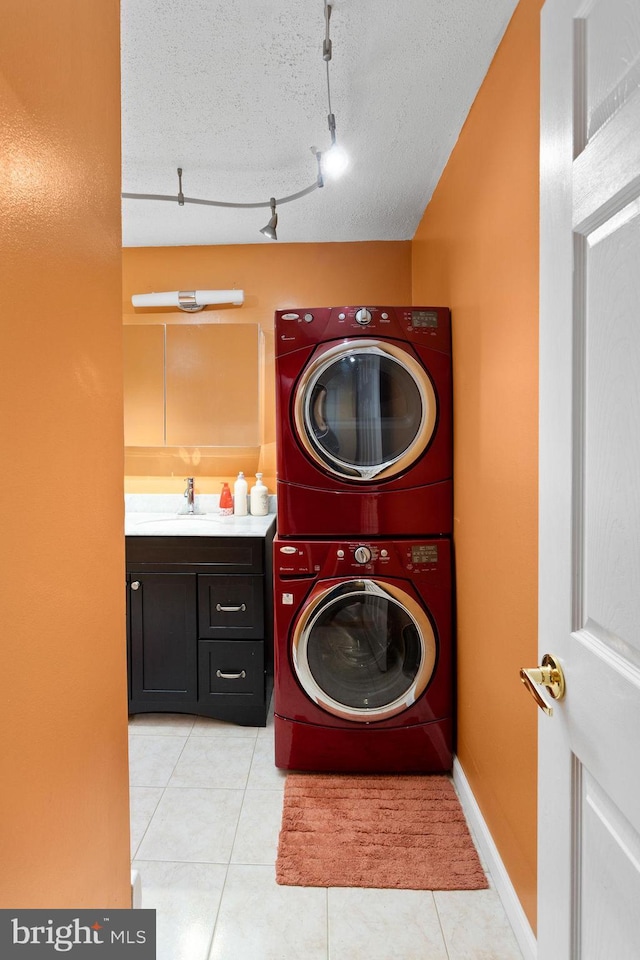132 The Orchards Unit I, East Windsor, NJ 08520 - laundry room featuring estacked washer and dryer and light tile patterned floors