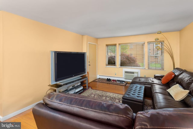 132 The Orchards Unit I, East Windsor, NJ 08520 - living room featuring wood finished floors, baseboard heating, baseboards, and a wall mounted air conditioner