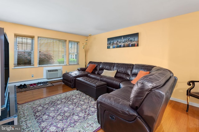 132 The Orchards Unit I, East Windsor, NJ 08520 - living room with wood finished floors, a wall unit AC, baseboard heating, and baseboards
