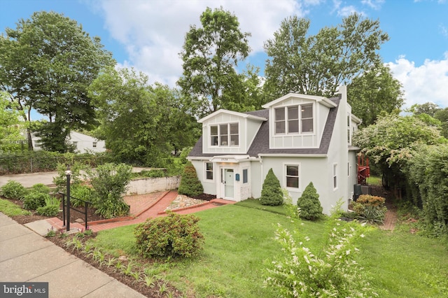 3134 Clayborne Ave, Alexandria, VA 22306 - view of front of home with roof with shingles, a front lawn, stucco siding, and central AC
