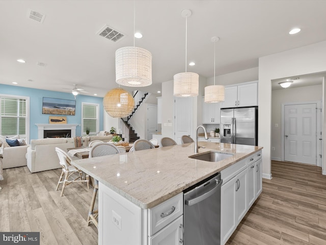 41 Beach Club Ave, Ocean View, DE 19970 - kitchen with appliances with stainless steel finishes, a sink, a kitchen bar, ceiling fan, and white cabinets