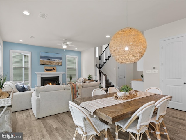 41 Beach Club Ave, Ocean View, DE 19970 - dining area featuring stairs, light wood-type flooring, ceiling fan, a warm lit fireplace, and recessed lighting