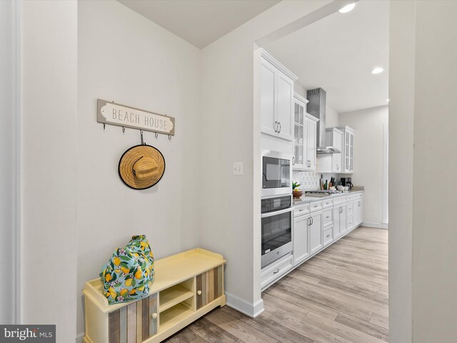 41 Beach Club Ave, Ocean View, DE 19970 - kitchen with wall chimney exhaust hood, baseboards, light wood-style flooring, white cabinets, and recessed lighting