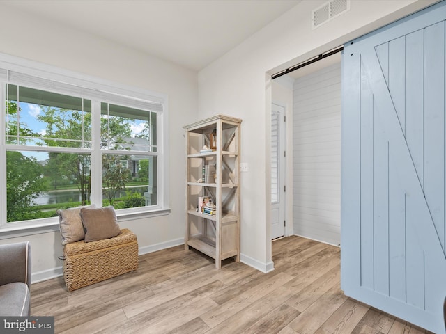 41 Beach Club Ave, Ocean View, DE 19970 - living area featuring light wood-style floors, a barn door, and baseboards