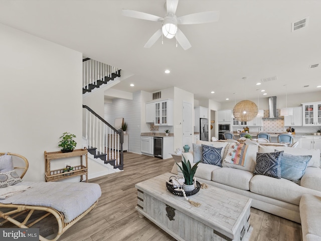 41 Beach Club Ave, Ocean View, DE 19970 - living room with beverage cooler, stairs, light wood finished floors, a ceiling fan, and recessed lighting