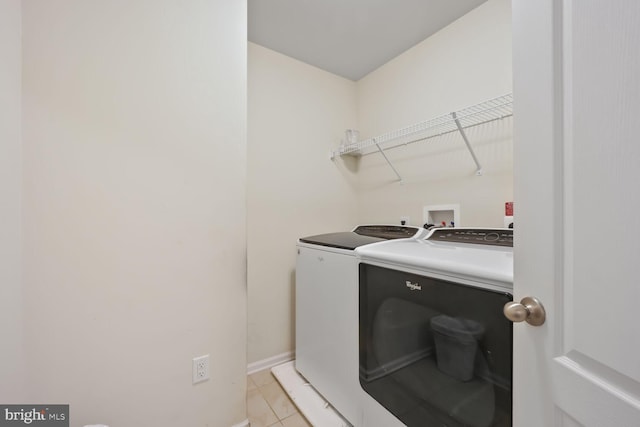 4504 Eden Park Ln, Upper Marlboro, MD 20772 - laundry area with washer and dryer, light tile patterned flooring, and baseboards