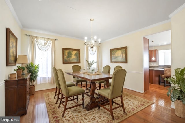 4504 Eden Park Ln, Upper Marlboro, MD 20772 - dining room featuring light wood finished floors, a chandelier, ornamental molding, and baseboards