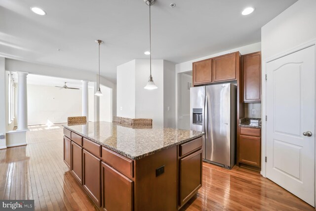 4504 Eden Park Ln, Upper Marlboro, MD 20772 - kitchen with stainless steel refrigerator with ice dispenser, ornate columns, ceiling fan, hardwood / wood-style floors, and a center island
