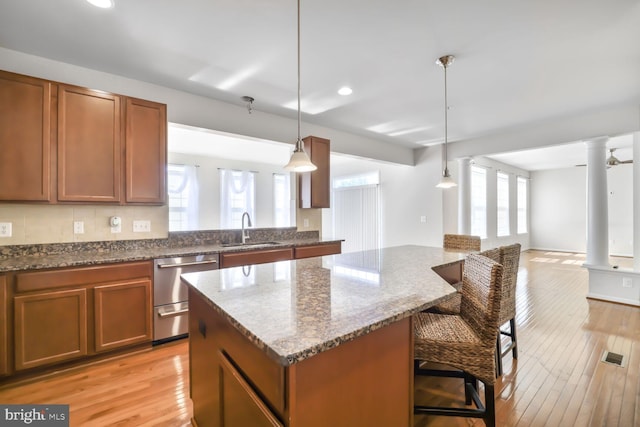4504 Eden Park Ln, Upper Marlboro, MD 20772 - kitchen featuring a sink, dishwasher, ornate columns, a kitchen island, and open floor plan