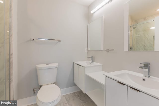1947 N 33rd St, Philadelphia, PA 19121 - full bathroom with two vanities, marble look tiles, a stall shower, toilet, and baseboards