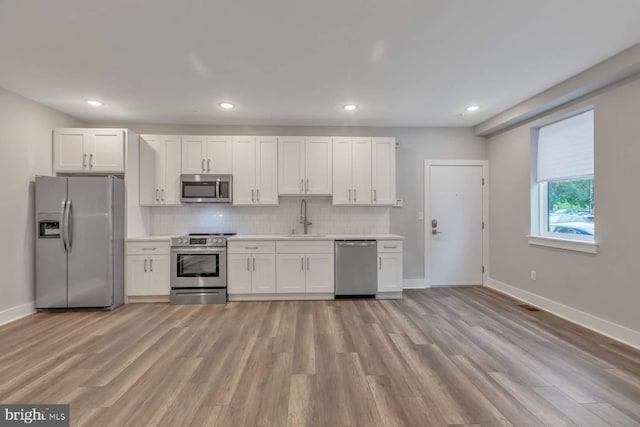 1947 N 33rd St, Philadelphia, PA 19121 - kitchen with appliances with stainless steel finishes, light wood-type flooring, baseboards, light countertops, and recessed lighting