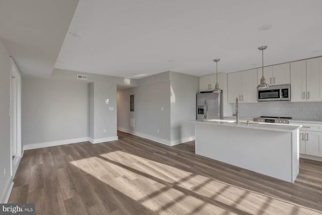1947 N 33rd St, Philadelphia, PA 19121 - kitchen with stainless steel appliances, tasteful backsplash, dark wood-style flooring, and light countertops