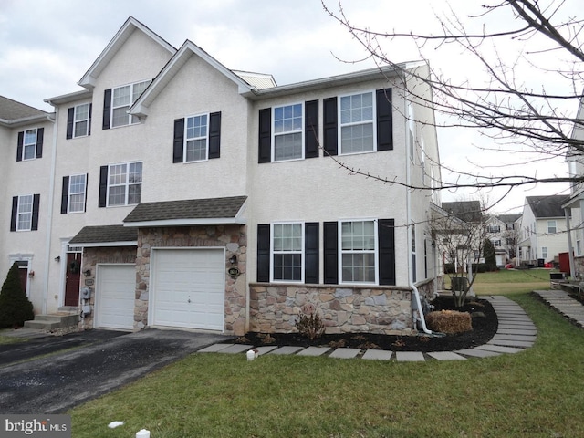 1664 Brynne Ln, Pottstown, PA 19464 - multi unit property featuring stone siding, asphalt driveway, a garage, a front lawn, and stucco siding