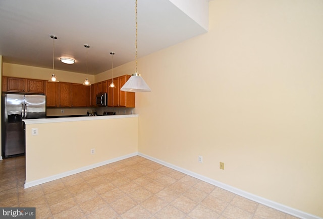 1664 Brynne Ln, Pottstown, PA 19464 - kitchen with stainless steel appliances, a peninsula, decorative light fixtures, and brown cabinetry