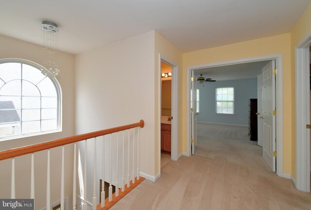 1664 Brynne Ln, Pottstown, PA 19464 - corridor with light colored carpet, an upstairs landing, baseboards, and a chandelier