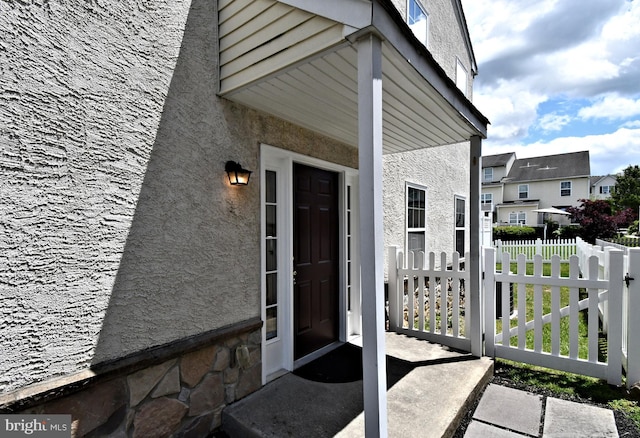 1664 Brynne Ln, Pottstown, PA 19464 - doorway to property with stucco siding, a residential view, and stone siding