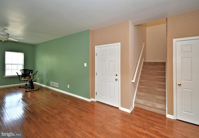 1664 Brynne Ln, Pottstown, PA 19464 - spare room featuring wood finished floors, a ceiling fan, stairs, and baseboards