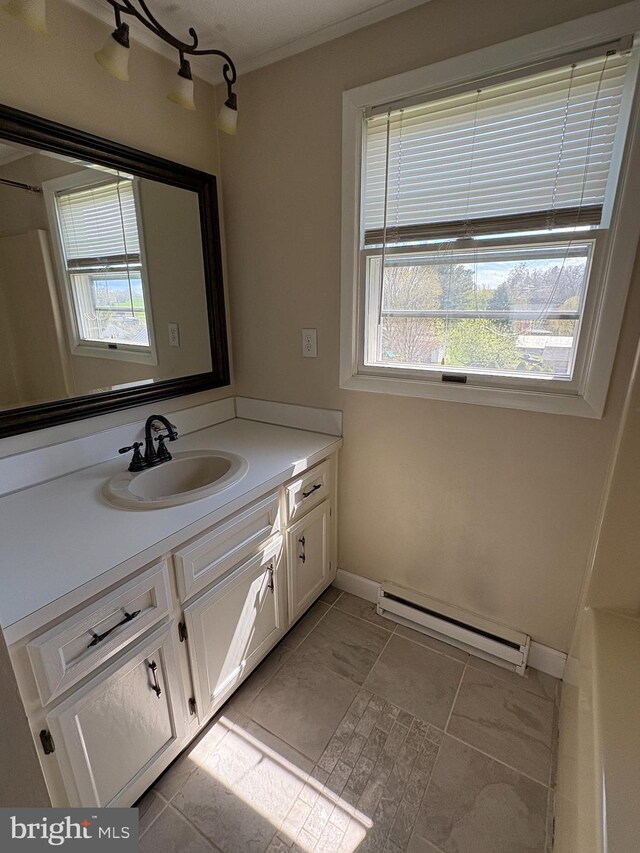 16 W Ninth St, Waynesboro, PA 17268 - full bath with a baseboard radiator, vanity, plenty of natural light, baseboards, and ornamental molding