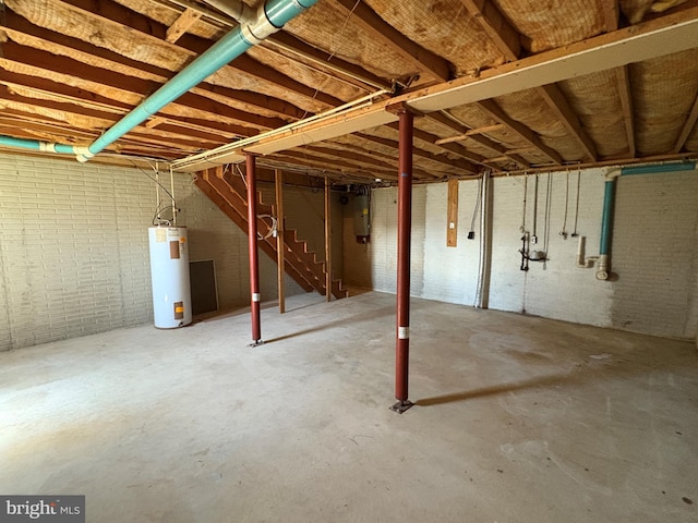 16 W Ninth St, Waynesboro, PA 17268 - unfinished below grade area with water heater, stairs, electric panel, and brick wall