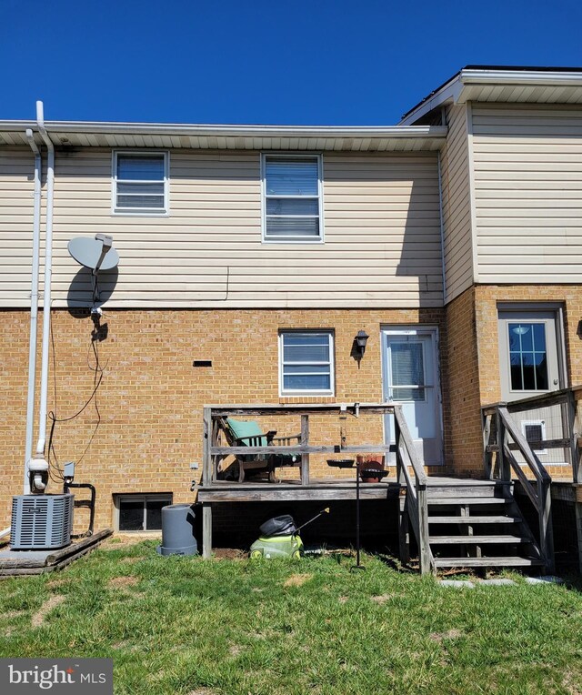 16 W Ninth St, Waynesboro, PA 17268 - back of house featuring a deck, central AC unit, brick siding, and a lawn