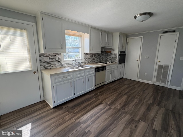 16 W Ninth St, Waynesboro, PA 17268 - kitchen featuring dishwashing machine, a sink, black oven, light countertops, and decorative backsplash